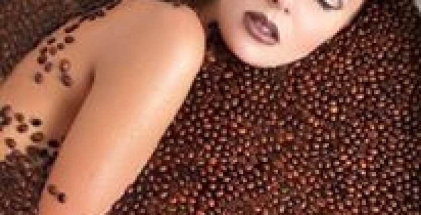 Lady in bath of coffee beans